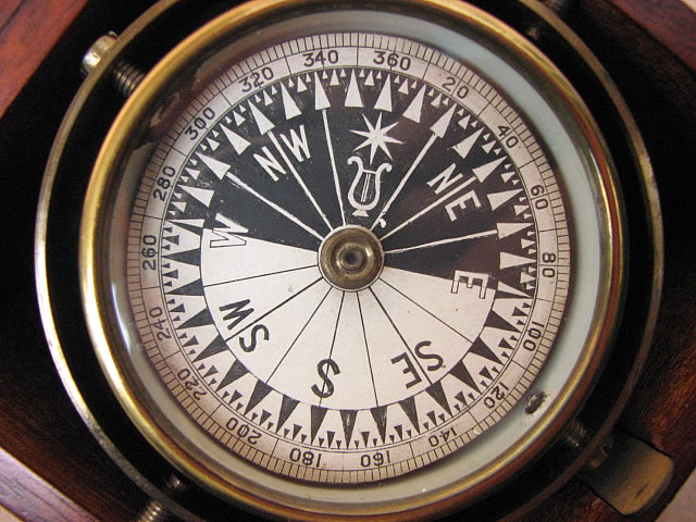 Close up view of singers patent style compass dial